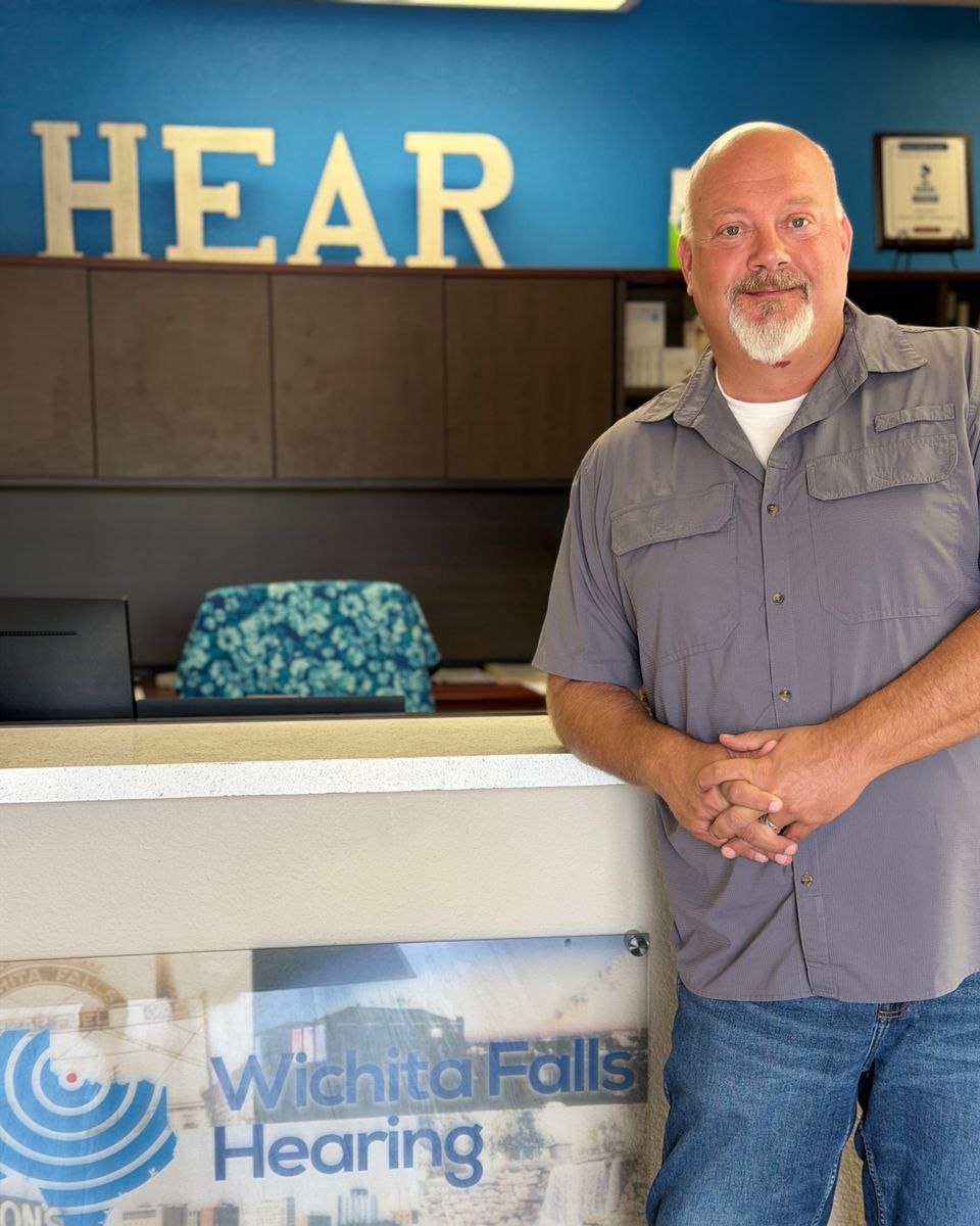Dusty Potter standing at the reception desk of his hearing practice in Wichita Falls, Texas.